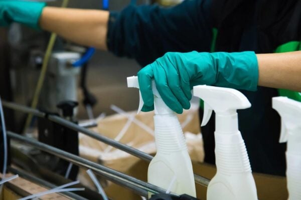 Hands with gloves using spray bottles
